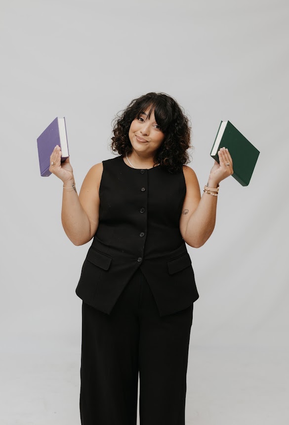 Stephanie holding up a purple and a green notebook
