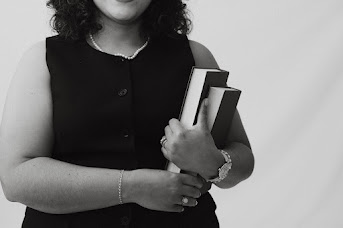 Holding notebooks, black and white