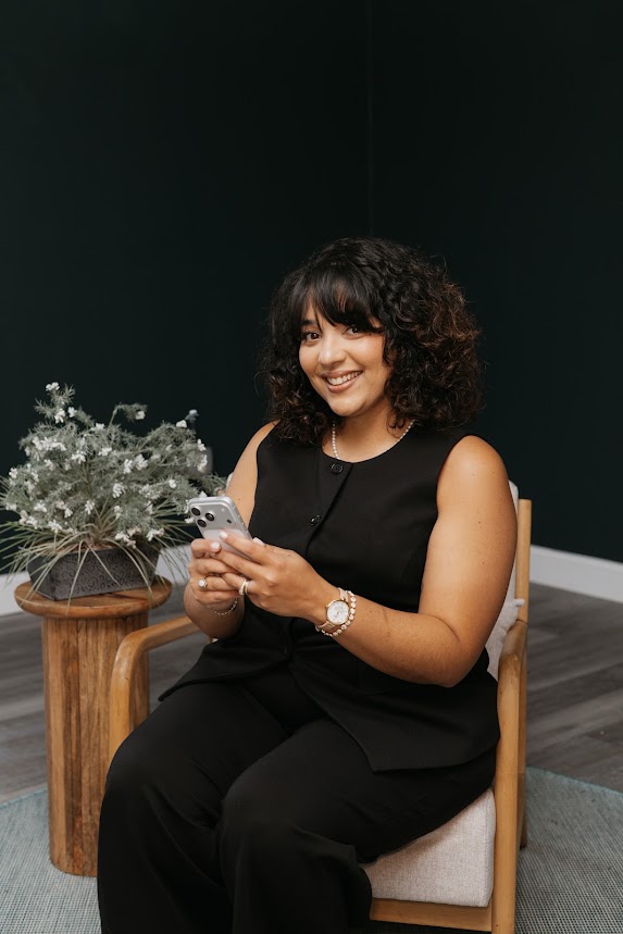 Seated portrait in a deep teal room